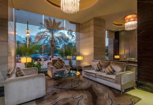 a living room with couches and a chandelier at Boudl Al Qasr in Riyadh