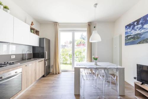 a kitchen with a table and chairs in a room at Appartamenti 1 in Dervio