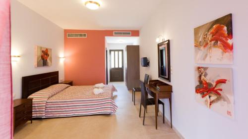 a bedroom with a bed and a desk in a room at Aenaon Rooms in Nafplio