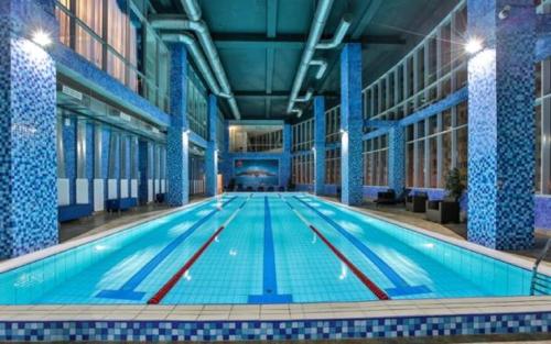 a large swimming pool in a large building at Triumph Hotel in Obninsk