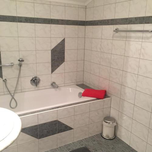 a bath tub in a bathroom with a red towel at Gstreinhof in Längenfeld