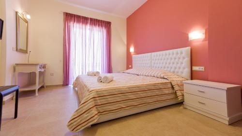 a bedroom with a bed with two towels on it at Aenaon Rooms in Nafplio