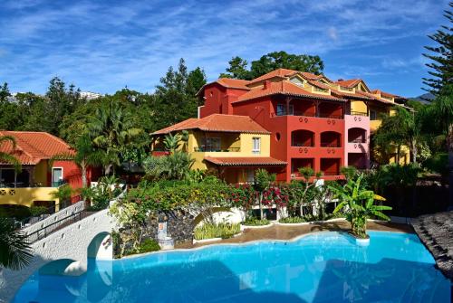 a resort with a swimming pool in front of a building at Pestana Village Garden Hotel in Funchal
