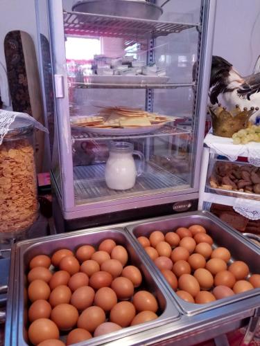 an open refrigerator filled with lots of eggs at Anatoli Hotel in Agia Marina Aegina