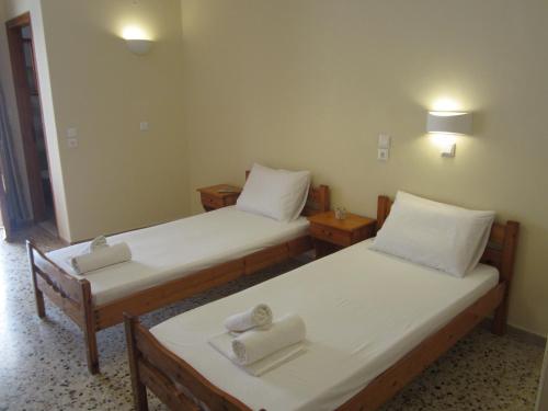 two beds in a room with towels on them at Dimitra appartements in Argostoli
