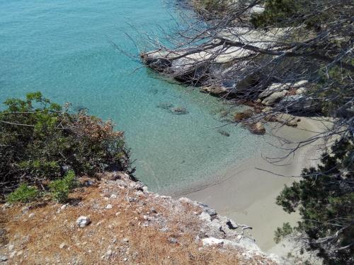 a view of a beach from a cliff at Anatoli Hotel in Agia Marina Aegina