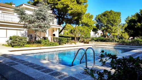 a swimming pool in front of a house at Villa Yate in L'Ametlla de Mar