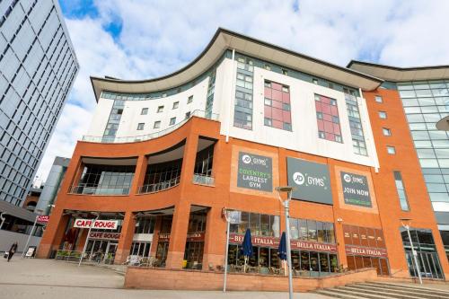 a large brick building in a city at Belgrade Plaza Serviced Apartments in Coventry
