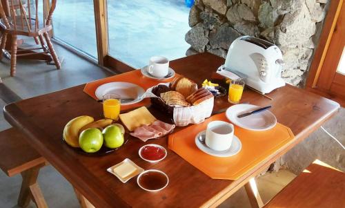 a table with a tray of breakfast food on it at Hotel El Refugio nudista naturista opcional in Chihuahua