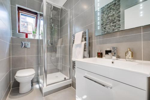 a bathroom with a toilet and a sink and a shower at Notting Hill Residences in London