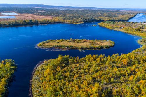 an aerial view of a lake in the fall at Aurora Mountain Lodge in Lannavaara
