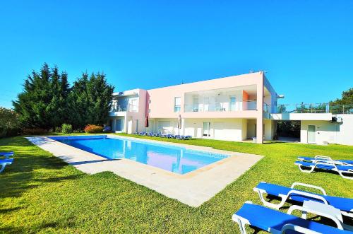 a villa with a swimming pool in front of a house at HILLTOP OASIS Lisboa Oeiras in Oeiras