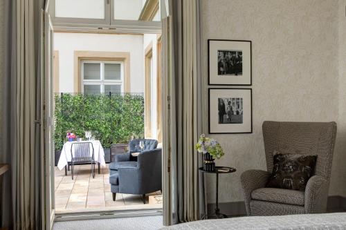 a living room filled with furniture and a window at Rocco Forte Villa Kennedy in Frankfurt/Main