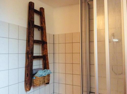a bathroom with a wooden shelf on the wall at Winzerhäuschen, Weingut Th. Müller in Reil