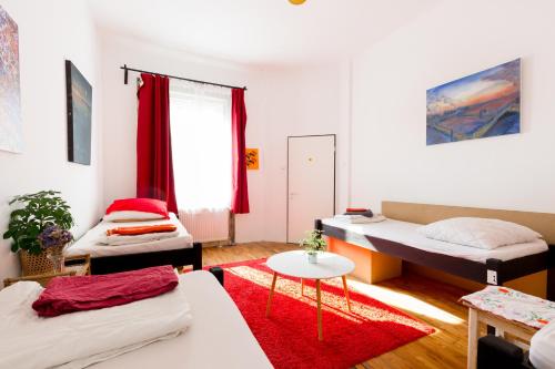 a room with a bed, a desk and a television at Das Nest Budapest in Budapest
