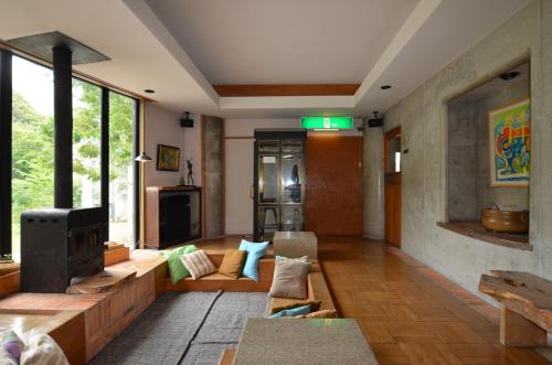 a living room with a couch and a fireplace at the Kinta Naeba in Yuzawa