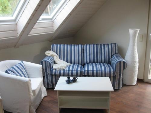 a living room with a couch and a coffee table at Scheunenhaus Kienspan in Tornitz