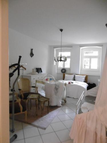 a bedroom with a bed and a table and chairs at Apartment Hermine in Görlitz