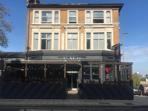 a building on a city street with a store at PubLove @ The Crown, Battersea in London