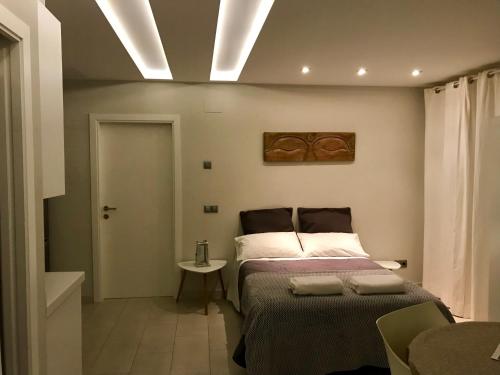 a bedroom with a bed and a ceiling with lights at Apartamentos Can Quim in L'Escala