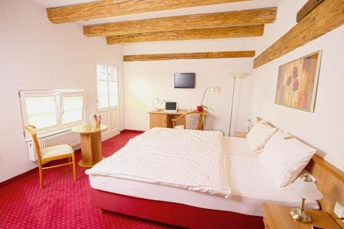 a bedroom with a bed and a desk in it at Château de Pourtalès in Strasbourg