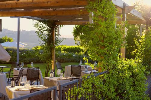 a table set up for a meal in a garden at Roccafiore Wine Resort & Spa in Todi
