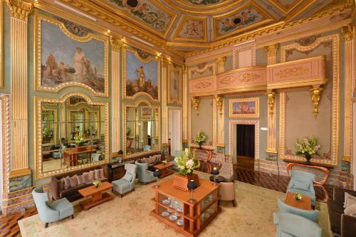 a living room filled with furniture and a large clock at Pestana Palácio do Freixo, Pousada & National Monument - The Leading Hotels of the World in Porto