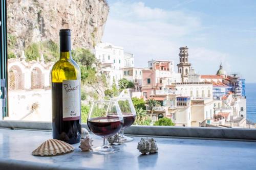 a bottle of wine and a glass on a table at La casa del capitano in Atrani