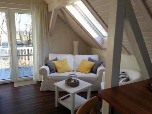 a living room with a couch and a table at Scheunenhaus Kienspan in Tornitz