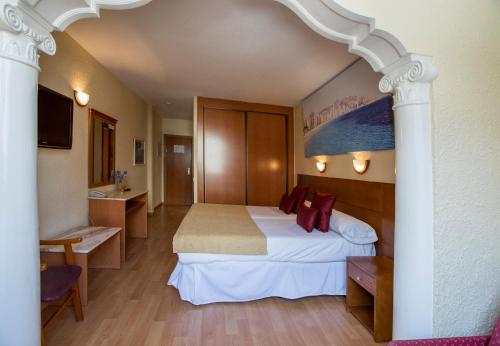 a hotel room with a bed and a desk at Magic Villa de Benidorm in Benidorm