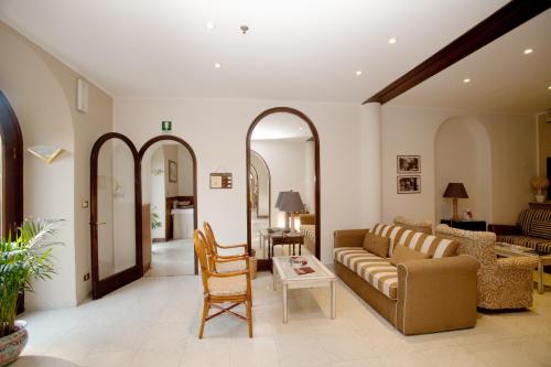 a living room filled with furniture and a large window at Hotel Giulio Cesare in Rapallo