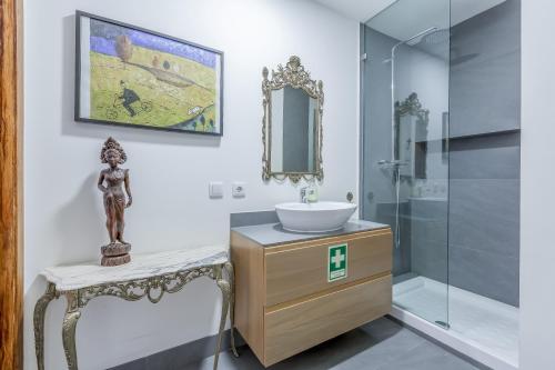 a bathroom with a sink and a mirror at Lisbon Downtown Apartment Figueira in Lisbon