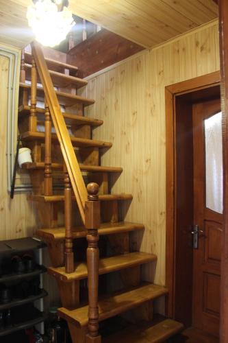 a wooden spiral staircase in a wooden house at У МИХАЙЛА під лісом in Verkhovyna
