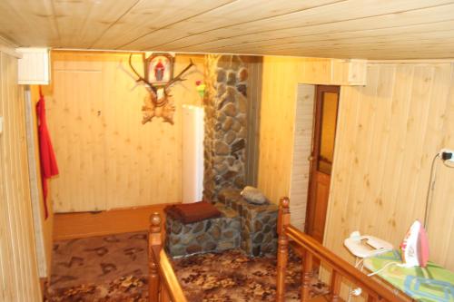 a room with a stone fireplace in a house at У МИХАЙЛА під лісом in Verkhovyna