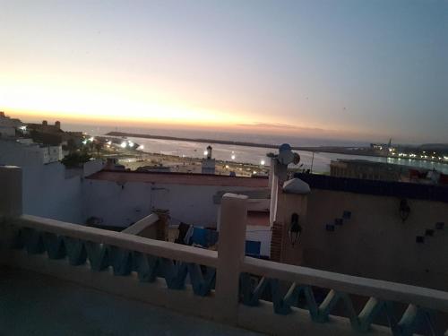 a view of the ocean at sunset from a rooftop at Sultana larache in Larache