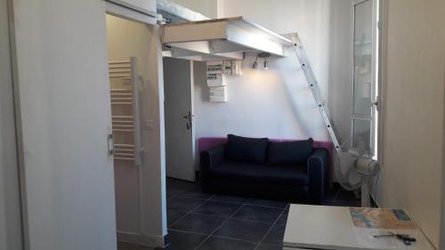 a room with a black chair and a ladder at Nice Apartment Backpackers S1 & S2 in Nice