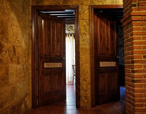 two wooden doors with the words fostoria written on them at Posada Puerta Grande in Candelario