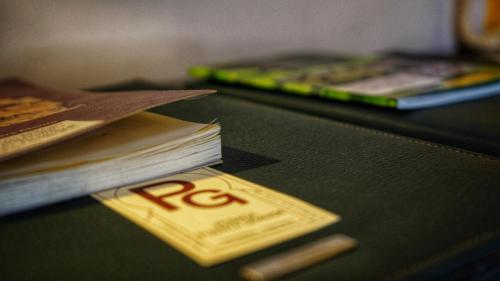 a close up of books on a table with a bar ofphrinephrinephrinephrine at Posada Puerta Grande in Candelario