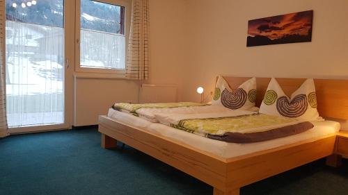 a bedroom with two beds and two windows at Ferienhaus Amann in Schruns-Tschagguns