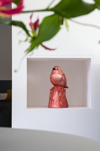 a small figurine of a bird sitting on a table at B&B StudioLKE in Heeze