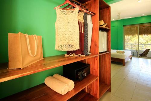 
a room with a shelf filled with books and bags at La Palmita Budget Boutique Hotel in Tulum
