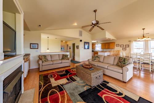 a living room with couches and a flat screen tv at Funtiki in Whalebone