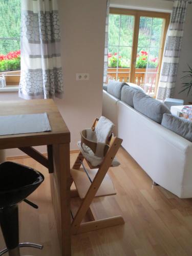 a living room with a table and a couch at Ascherhof in Auffach