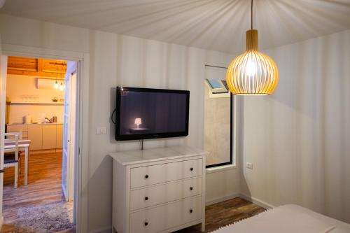 a tv on top of a dresser in a room at Eilat vacation house דירות נופש אילת in Eilat