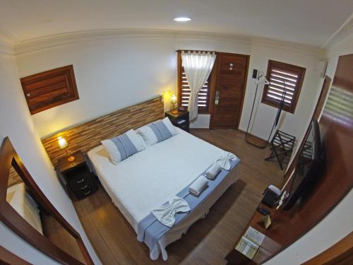 Postel nebo postele na pokoji v ubytování Hotel Vale das Nuvens