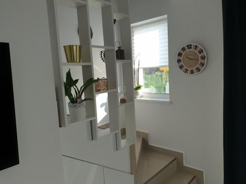 a staircase in a room with a window at VillaGrey Tunari in Tunari