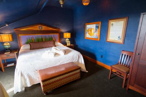a bedroom with a large bed and a chair at McMenamins Grand Lodge in Forest Grove