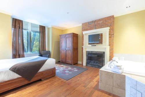 a bedroom with a bed and a fireplace and a television at Unilofts Grande-Allée in Quebec City