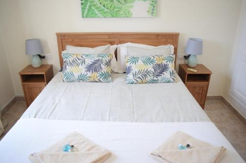 a bedroom with a bed with two towels on it at Villa Imogen with NEW HEATED SWIMMING POOL in Playa Blanca