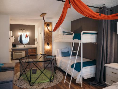 a bedroom with two bunk beds and a mirror at LOGE Bend in Bend